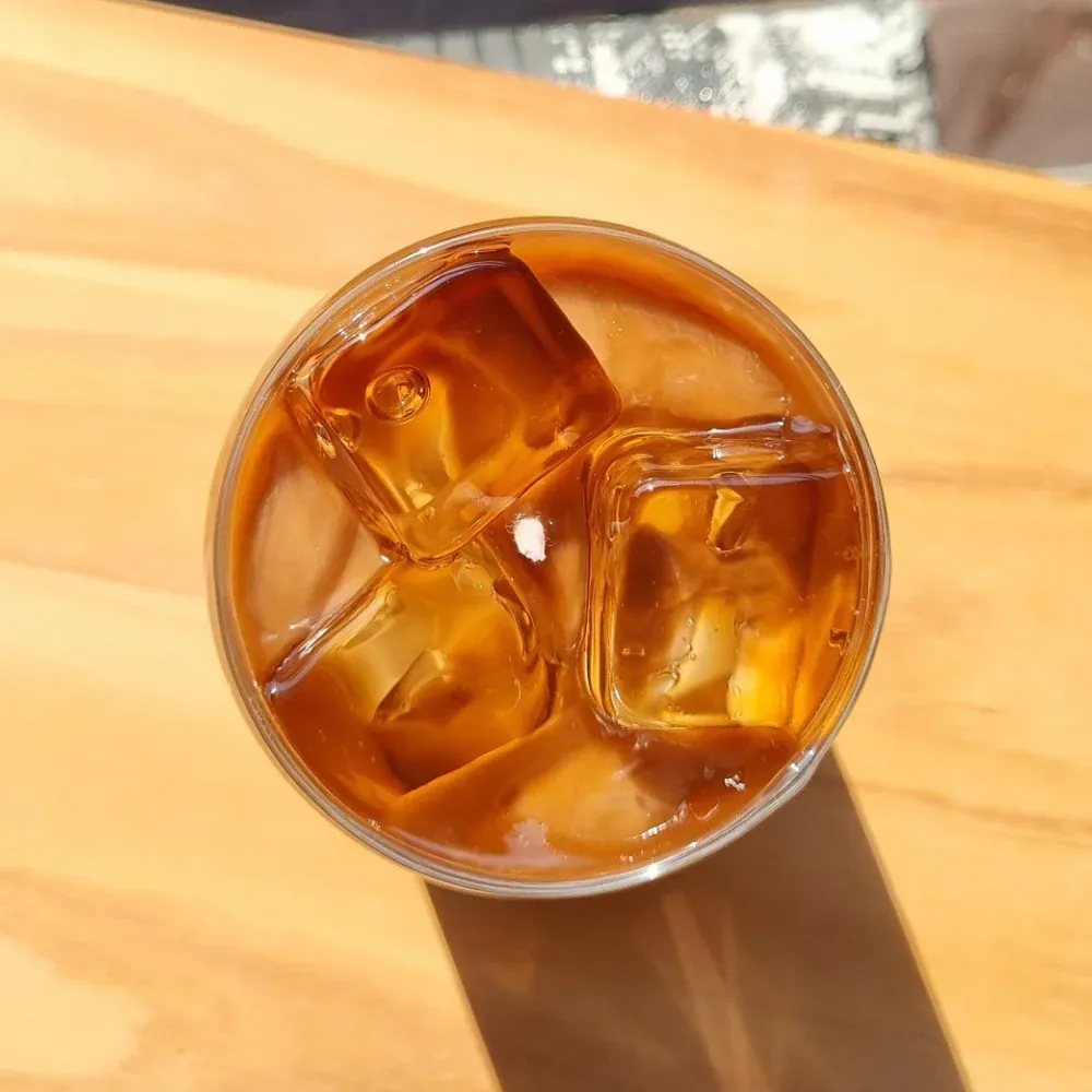 Vela Iced Latte vista de cima, com camadas de leite e café e cubos de gelo de cera